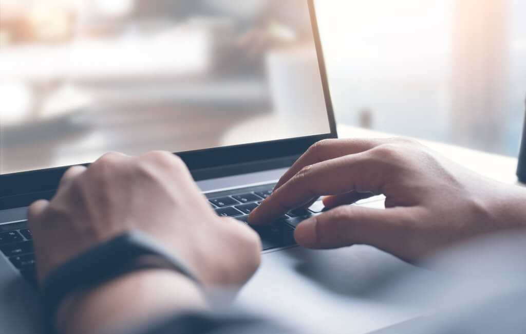 Close up of a man on his laptop | How to increase organic traffic