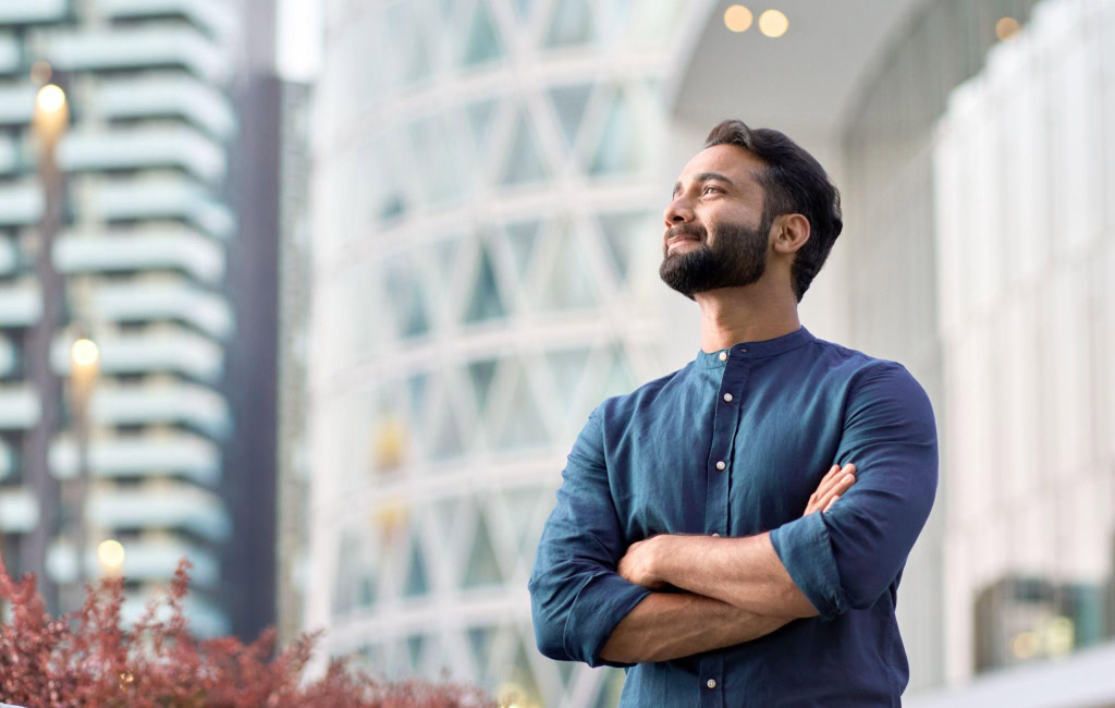 Optimistic man brainstorming company goals | Uber’s North Star Metric