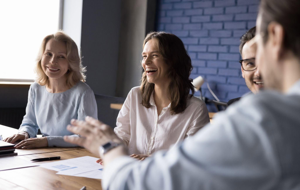 Colleagues discussing their wins in a room | Uber’s North Star Metric