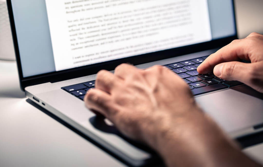 Person writing on laptop | On-Page SEO issues