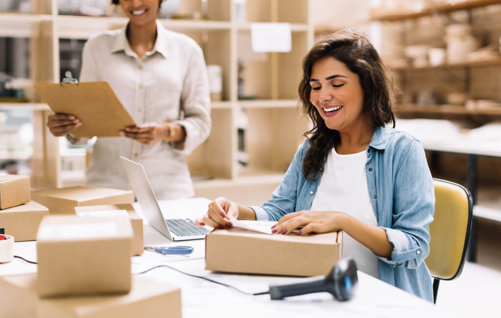 Two women packing multiple online orders | Amazon’s North Star Metric