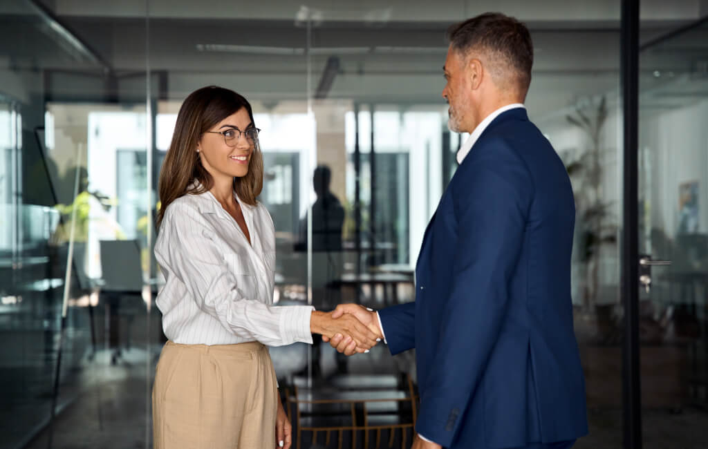 Handshake between a man and a woman | Automate LinkedIn ads