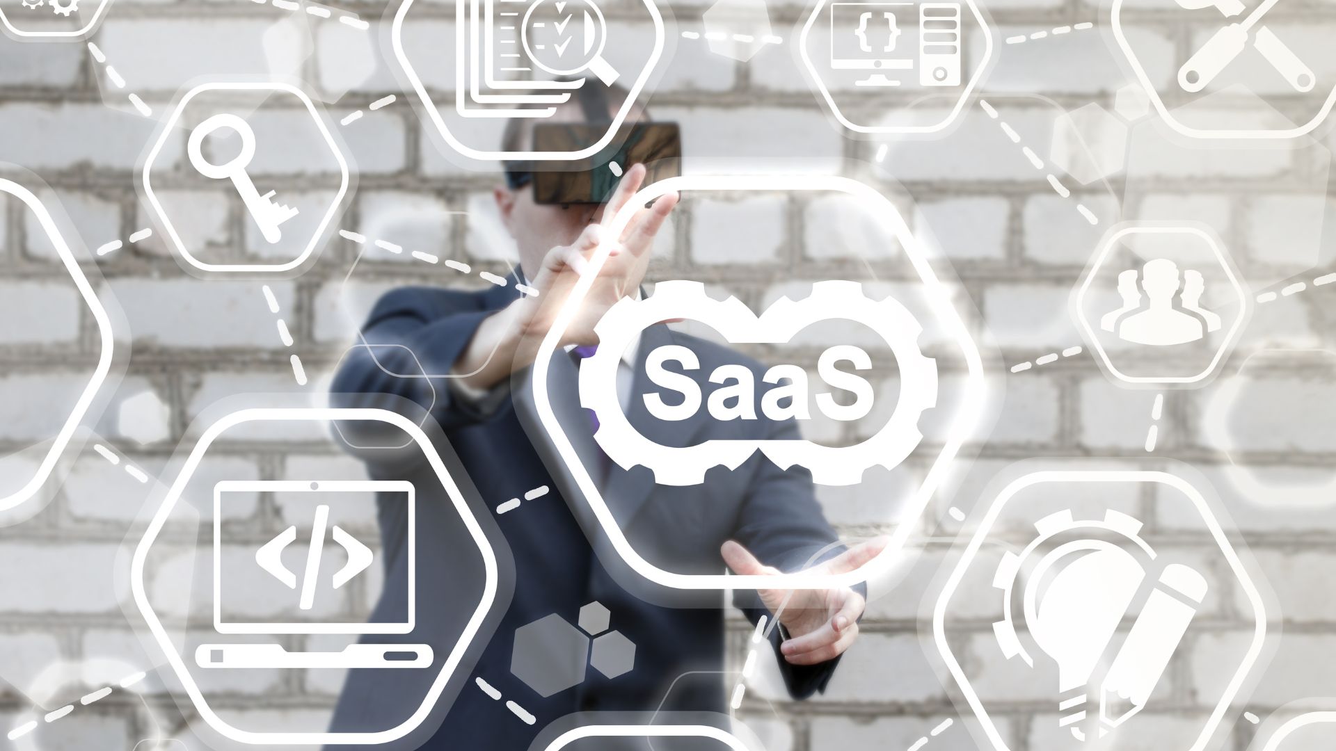 Man in VR headset sees glowing diagram of SaaS icons | Scale Effects for Product Defensibility