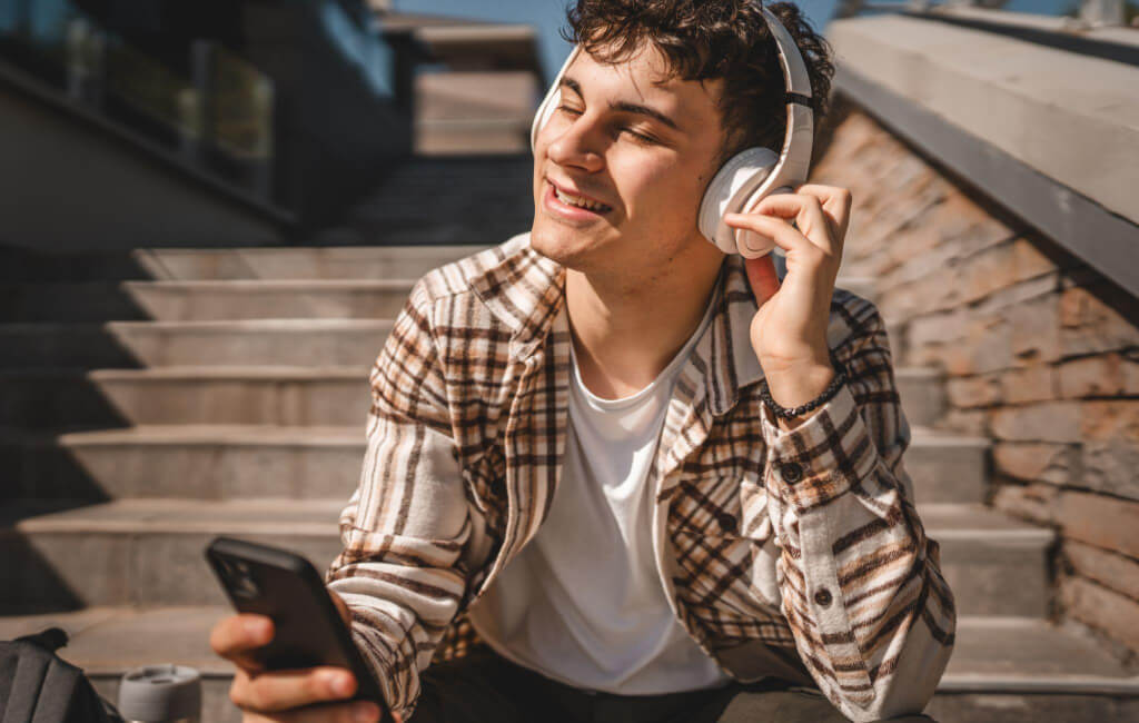Man on stairs listening to music | Spotify’s North Star Metric