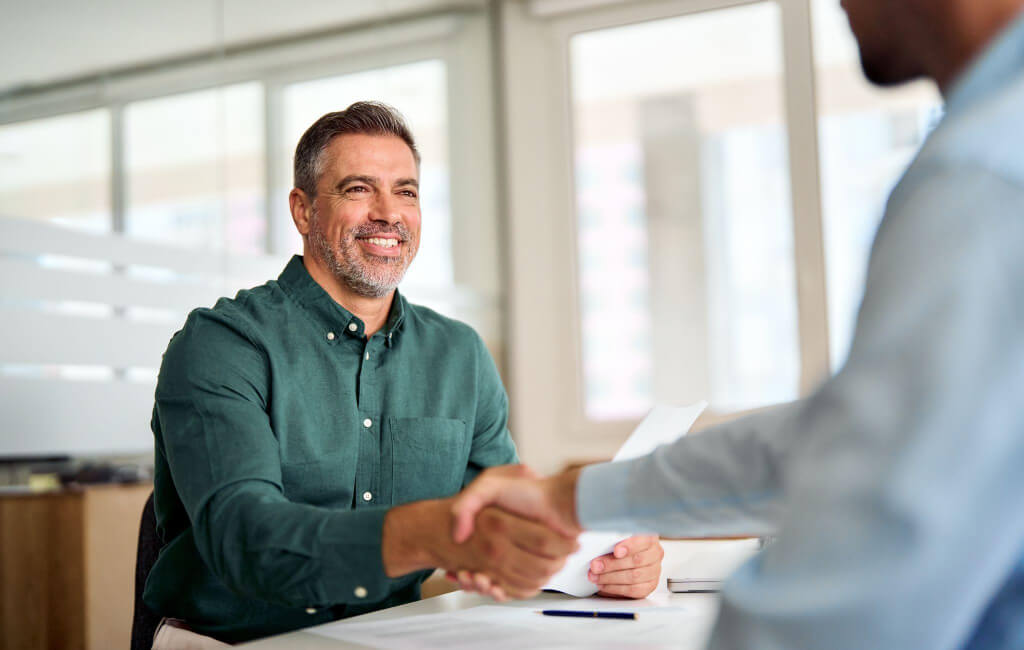 Man shaking hands with another man | On-Page SEO issues