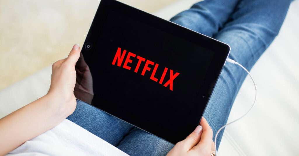 Person working with data on laptop |Netflix’s North Star metric