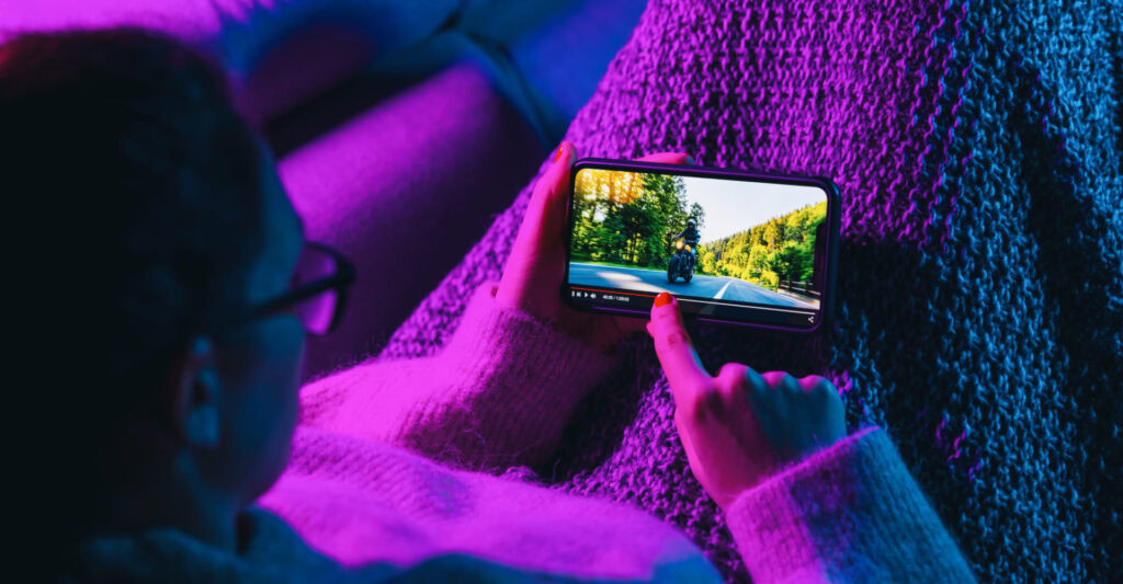 Woman watching streaming on phone |Netflix’s North Star metric