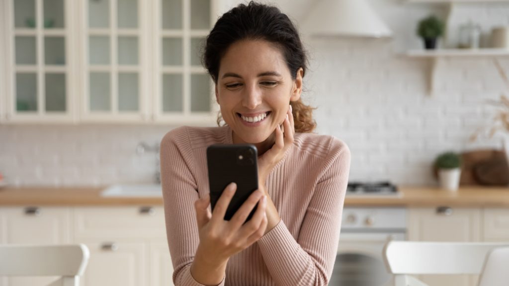 Woman Smiling at Phone | Not Measuring Engagement | Teknicks