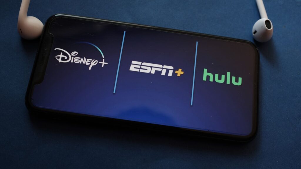 Disney+, ESPN, and Hulu logos displayed on smartphone screen | Brand Network Effects for Streaming Companies