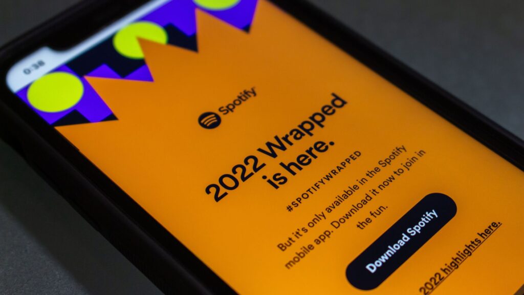 Smartphone displays orange Spotify Wrapped advertising campaign | Customer Acquisition Costs