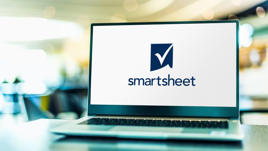 Close up of Smartsheet logo displaying on silver laptop in bright office | Customer Acquisition Costs