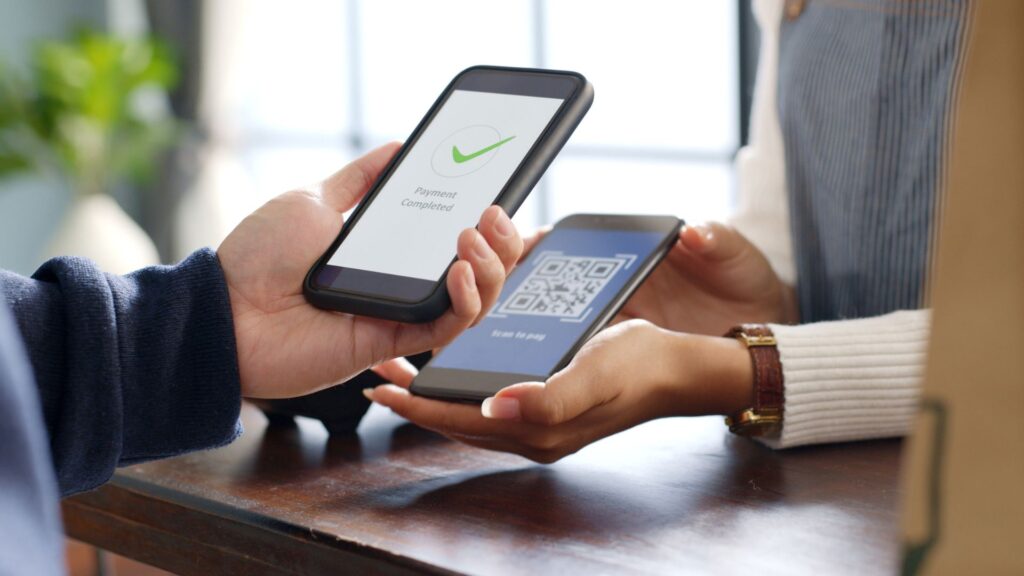 Close-up of SaaS user using QR code to complete payment on smartphone | ARPPU