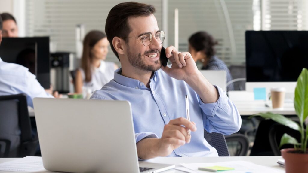 SaaS manager smiles while talking to Teknicks team on cell phone | Finding the Right SaaS Users