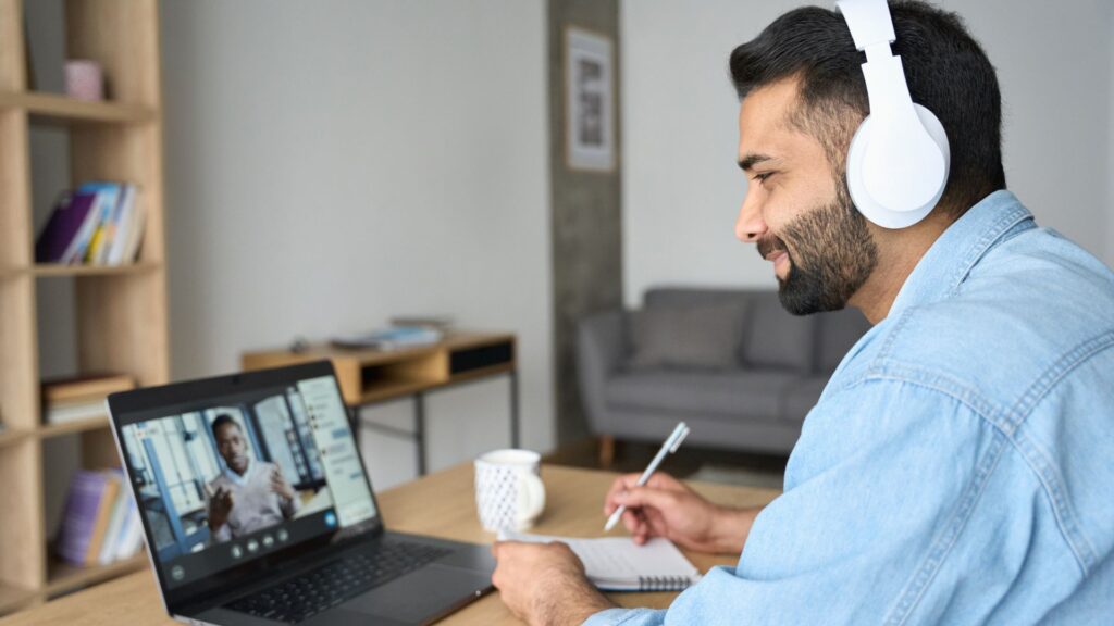 SaaS manager uses laptop to video chat with Teknicks team | Measuring Network Effects